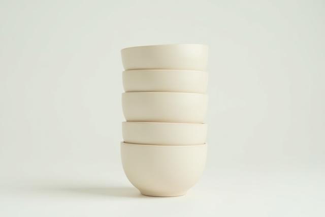 Collection of 100 customized yunomi tea cups with a subtly debossed company logo